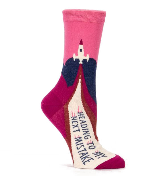 Graphic crew socks with rocket ship illustration say, "Heading to My Next Mistake"