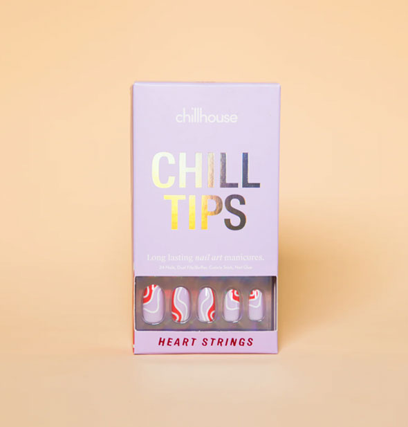 Purple box of Chillhouse Chill Tips press-on nails in the style Heart Strings, five of which can b e seen through a window in packaging