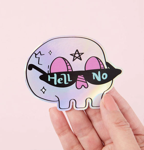 Model's hand holds a Hell No holographic skull sticker