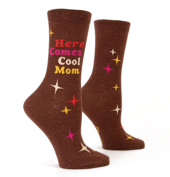 Brown crew socks say, "Here Comes Cool Mom" in red, pink, white, and yellow lettering surrounded by stars in the same colors