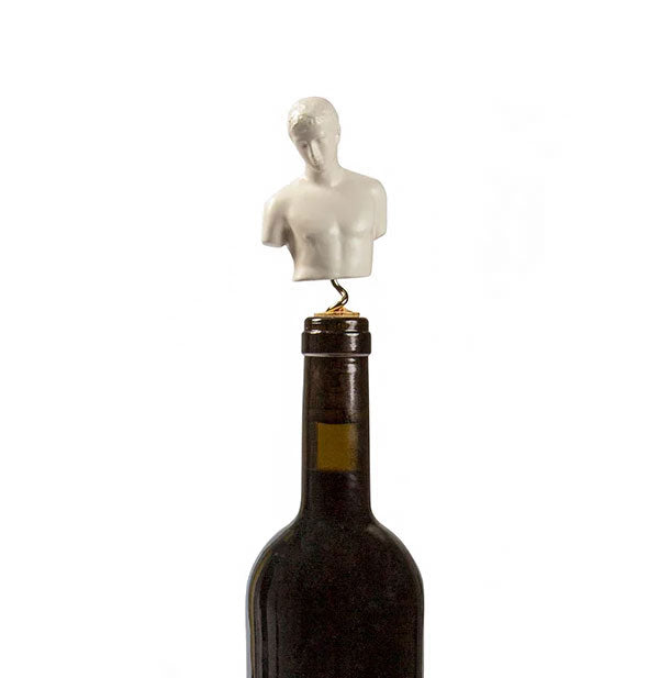 Greek god bust sculpture corkscrew emerges from a wine bottle's cork