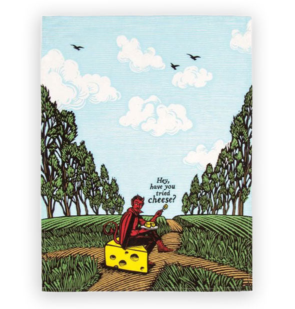 Dish towel depicting a red devil sitting on a large slice of yellow cheese in a pastoral setting holding a plate and fork with cheese on them says, "Hey have you tried cheese?"