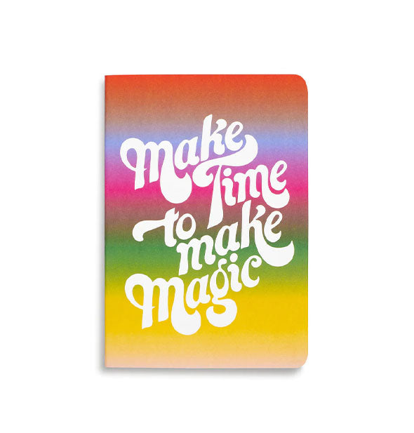 Rainbow ombre notebook cover says, "Make Time to Make Magic" in large white italicized lettering