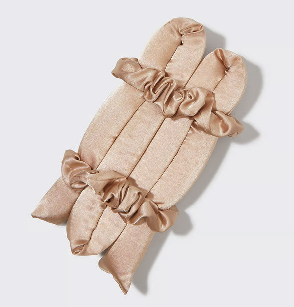 Folded champagne satin hair roller bound by two matching scrunchies