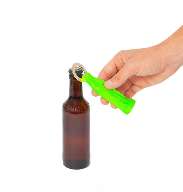 Model's hand demonstrates use of a green Holy Beer Bottle Opener