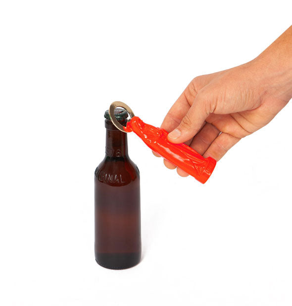 Model's hand demonstrates use of an orange Holy Beer Bottle Opener