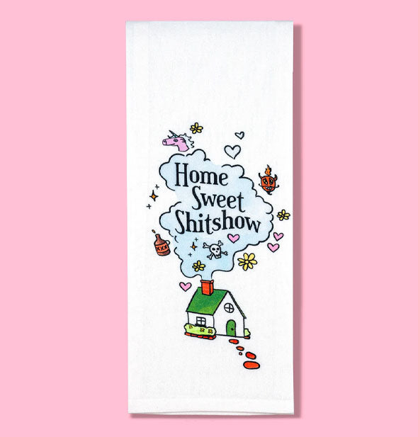 White dish towel features illustration of a white house with green roof emitting smoke from a red chimney that's surrounded by hearts, flowers, skull and crossbones, unicorn, devil, and other symbols and says, "Home Sweet Shitshow"