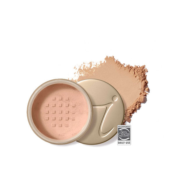 Opened round Jane Iredale loose powder compact with stamped gold lid and product application behind it in shade Honey Bronze