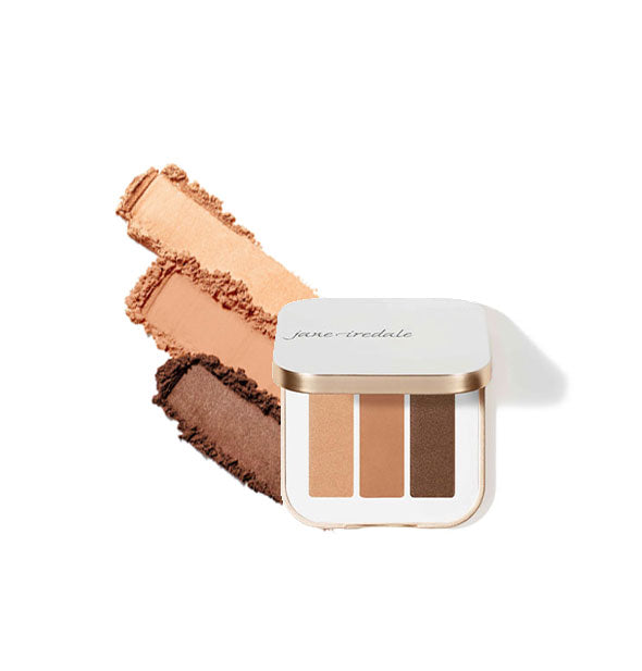 Opened white and gold square Jane Iredale eye shadow compact contains three shades in brown and neutral hues