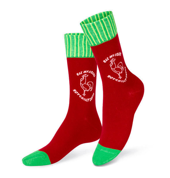 Red socks with green toes and green and white striped top bands feature a rooster logo in white at the ankles that says, "Eat My Socks" and "Hot Chilly Sauce"