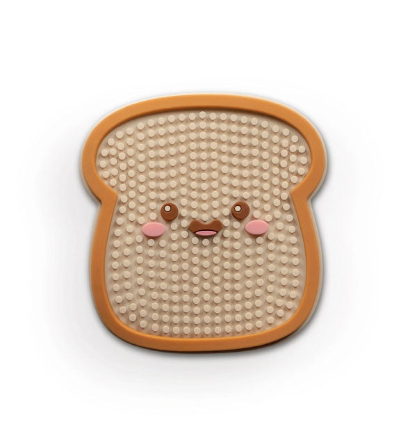 Notch-textured silicone mat resembles a piece of toast with smiley face in the center