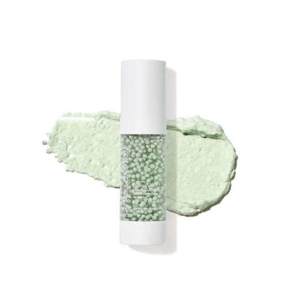 Cylindrical bottle of Jane Iredale serum filled with green spheres and backed with a thick sample application of product