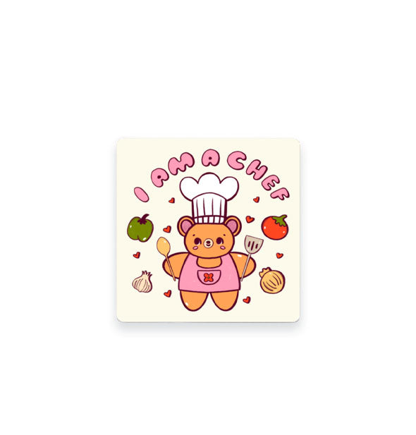 Square white sticker with rounded corners features illustration of a bear holding a spoon and spatula surrounded by hearts and vegetables and the words, "I am a chef" at the top in pink bubble lettering