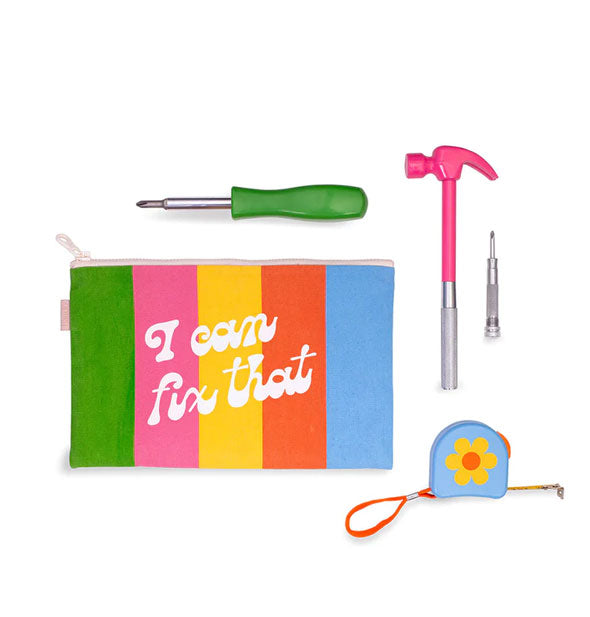 Colorful striped pouch that says, "I can fix that" in white script, hammer with pink head, screwdriver with green handle, and blue tape measure with yellow and orange flower accent