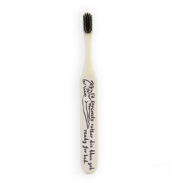 White toothbrush with black bristles and illustrated woman's figure with the phrase, "I'd seriously rather die than get ready for bed."