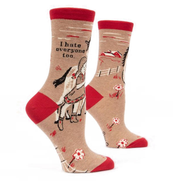 Pair of tan socks with red accents each feature a monochromatic design of a girl with horse in a pasture beneath the caption, "I hate everyone too" in black lettering