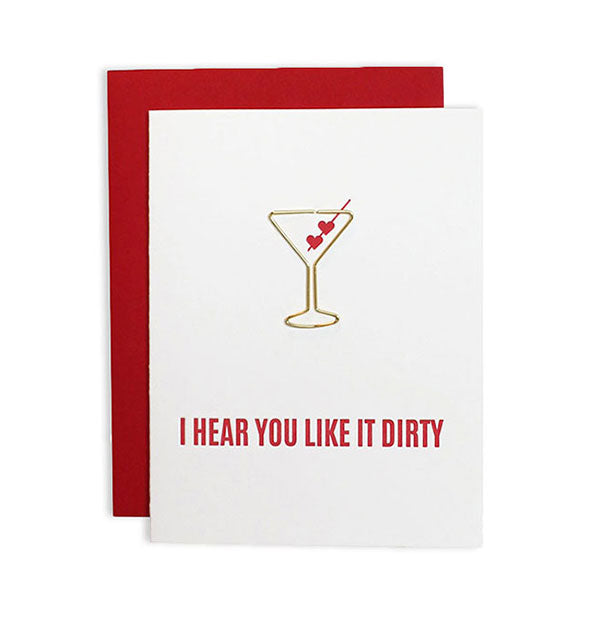 White greeting card imprinted “I Hear You Like It Dirty“ with gold martini-shaped paper clip attached and red envelope behind.