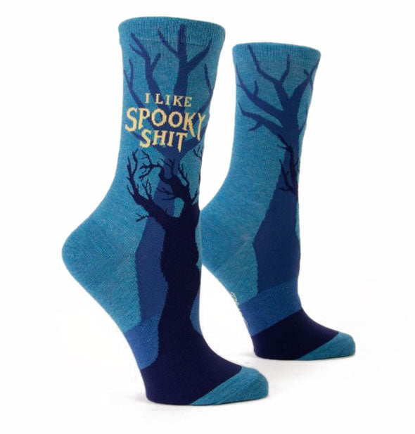 Pair of blue crew socks with bare trees design say, "I Like Spooky Shit" in yellow lettering