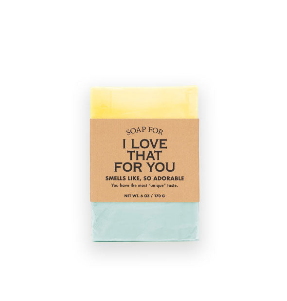 Bar of Soap for I Love That For You (Smells Like, So Adorable) is light yellow and aquamarine and wrapped in brown paper with black lettering