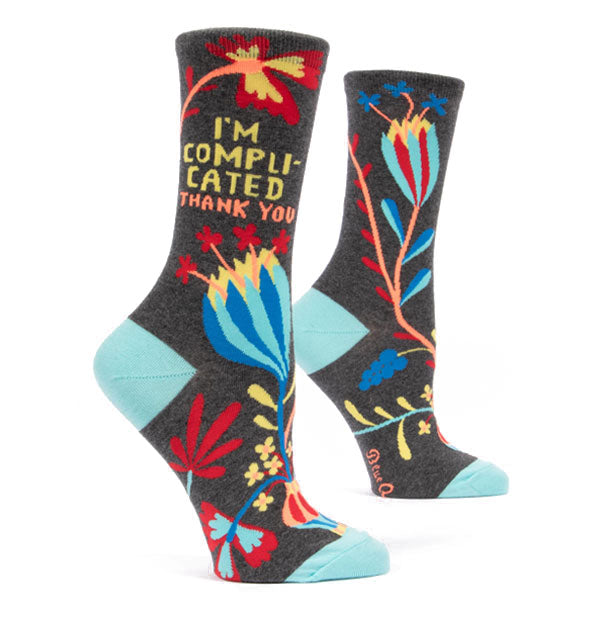 Dark grey crew socks with colorful floral design and "I'm complicated thank you" printed on the outer ankle