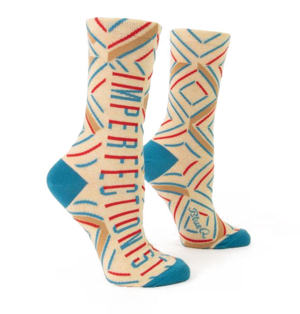 Cream-colored socks with colorful details say, "Imperfectionist" along the outer sides
