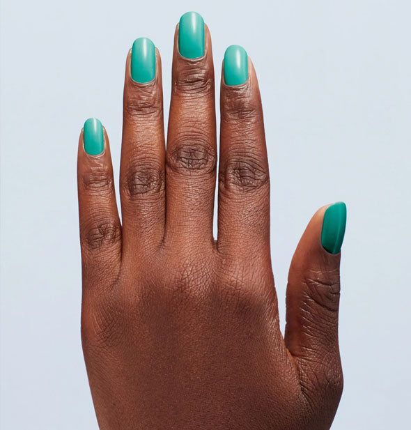 Model's fingernails are painted with teal nail polish