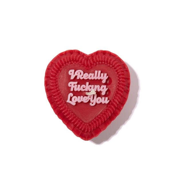 Red heart-shaped candle designed to resemble a decoratively frosted cake that says, "I really fucking love you" in pink script lettering