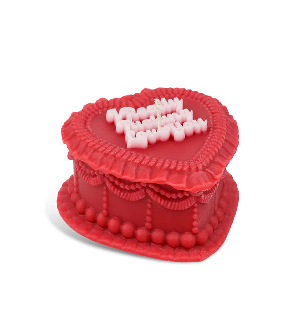 Red heart-shaped candle designed to resemble a decoratively frosted cake that says, "I really fucking love you" in pink script lettering