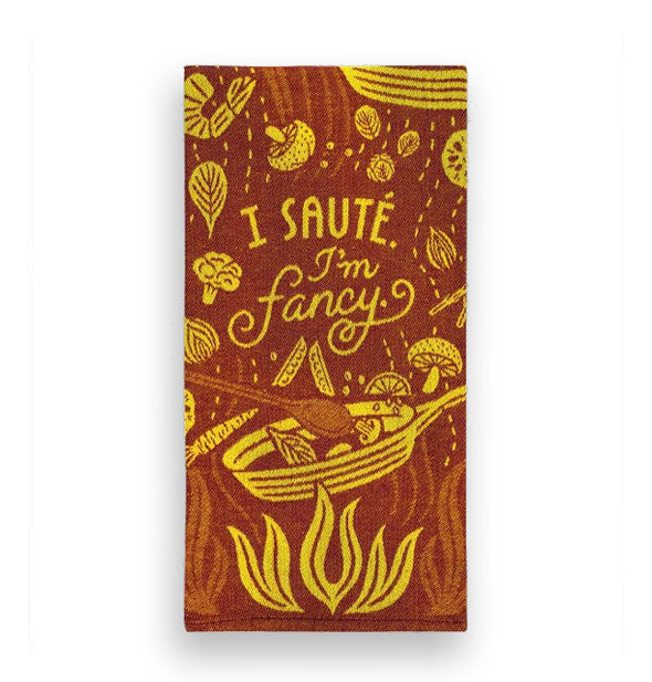 Brown and yellow dish towel with central design of a frying pan over a flame with vegetables, shrimp, herbs, and other food items flying all around says, "I sauté. I'm fancy."