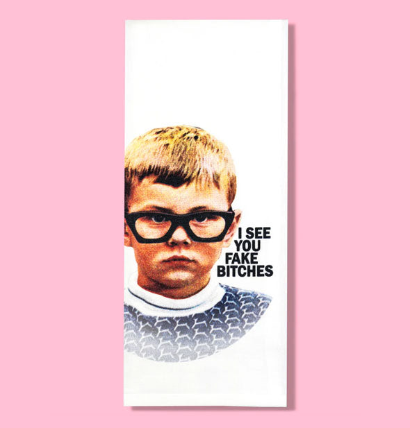 White dish towel with image of a child wearing thick-rimmed glasses says, "I see you fake bitches"