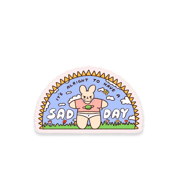 Sticker with an arced shape features illustration of a frowning bunny wearing a Saturn T-shirt and white undies in an outdoor setting with the words, "It's alright to have a sad day" incorporated into it