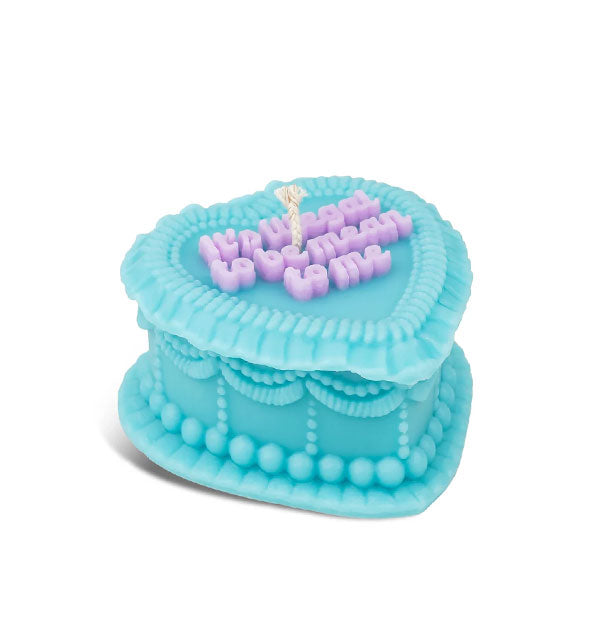 Blue candle designed to resemble a heavily decorated, blue heart-shaped cake iced with the message, "It's illegal to be mean to me" in purple lettering