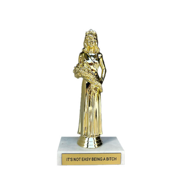 Trophy with gold prom queen figurine atop a white marble base inscribed with, "It's Not Easy Being a Bitch" on a gold placard