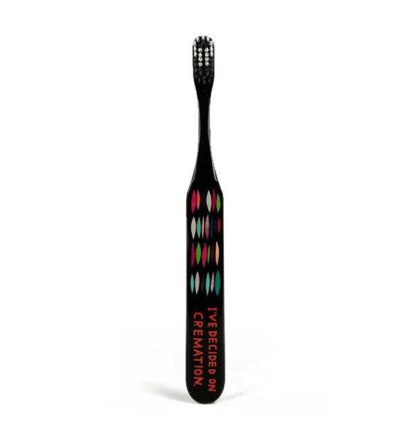 Black toothbrush with colorful embellishments says, "I've Decided on Cremation" in red lettering at the bottom
