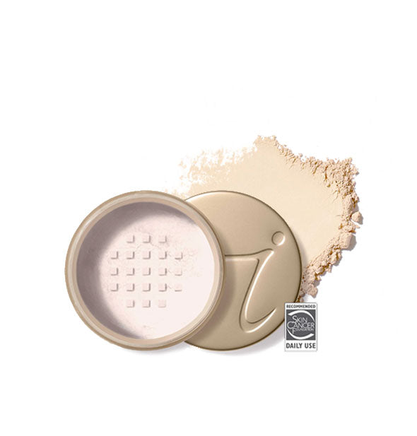 Opened round Jane Iredale loose powder compact with stamped gold lid and product application behind it in shade Ivory