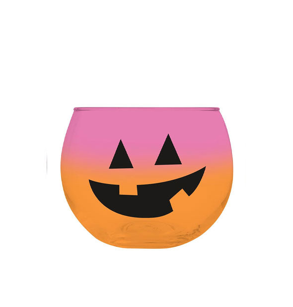 Squat stemless wine glass with black Jack-O'-Lantern face features an orange-to-pink ombre coloration