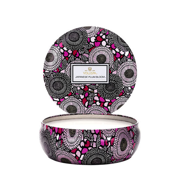 Round purple, black, and white floral Japanese Plum Bloom Voluspa candle tin with lid removed