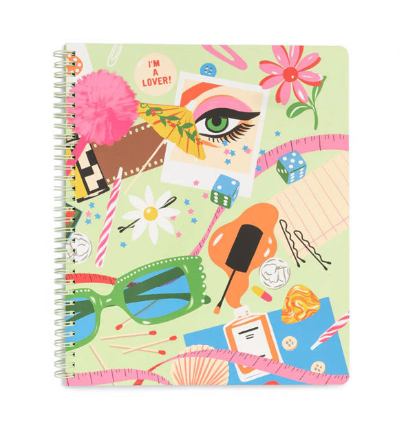 Spiral-bound notebook cover features all-over colorful illustrations including an eye, sunglasses, bobby pins, flower, umbrella, dice, and other items