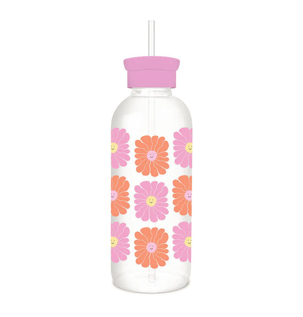 Clear glass water bottle with ad pink li straw and features  all-over print of pink and orange flowers with yellow smiley face centers 
