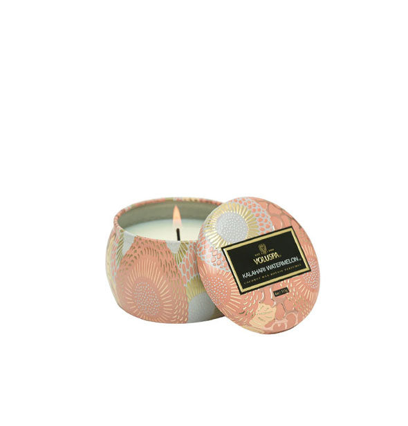 Small floral metallic Kalahari Watermelon Voluspa candle with matching lid set to the side