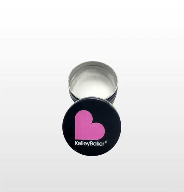Black and pink heart logo lid is removed from a pot of clear Kelley Baker Laminade brow gel