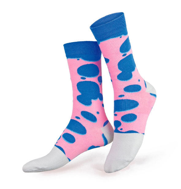 Pink crew socks with blue top band and oblong, irregular blue polka dot pattern, white heels, and white toes