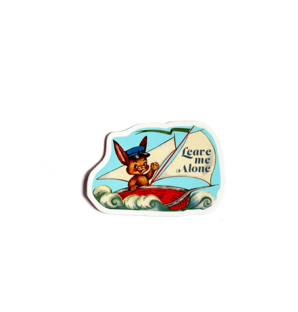 Sticker featuring illustration of a brown bunny in blue cap sailing over waves in a red sailboat with a sail that says, "Leave Me Alone"