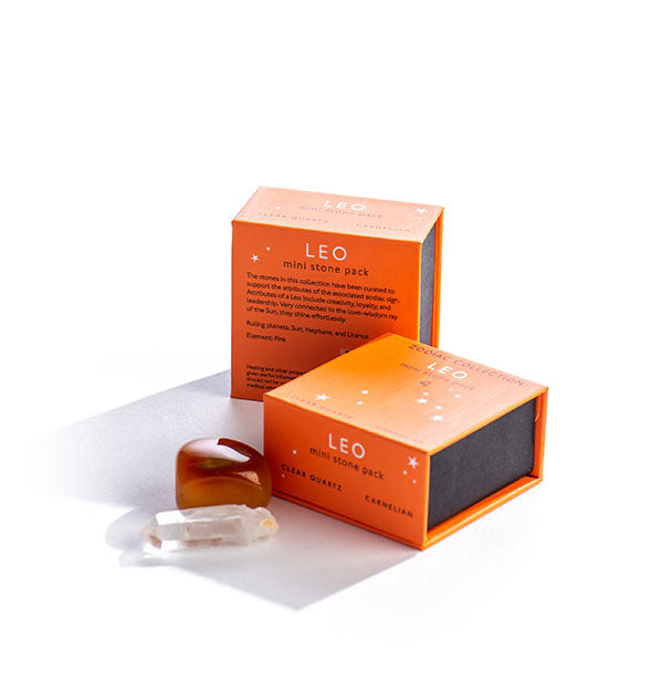 Two orange Leo Mini Stone Packs with crystals displayed in front