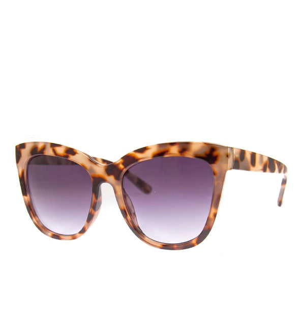 Pair of brown animal print sunglasses with a cat-eye shape and blueish-gray gradient lenses