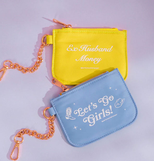 Blue Let's Go Girls! and yellow Ex-Husband Money coin purses with gold chain and zipper hardware