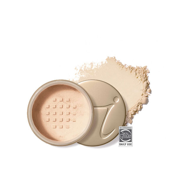 Opened round Jane Iredale loose powder compact with stamped gold lid and product application behind it in shade Light Beige