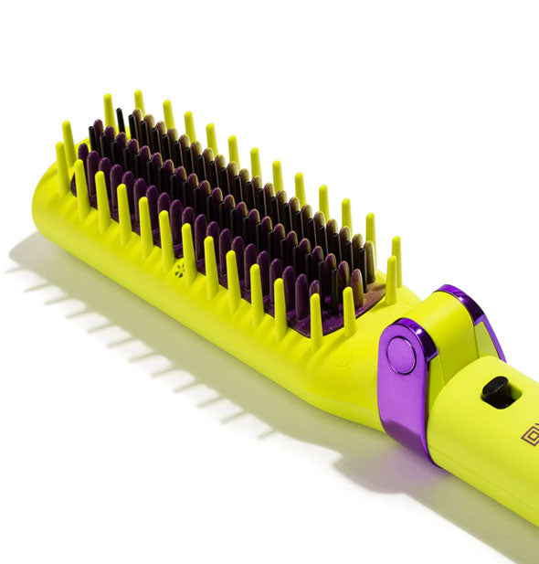 Angled view of the bristled head of a Glister Foldable Smoothing System brush iron in lime green