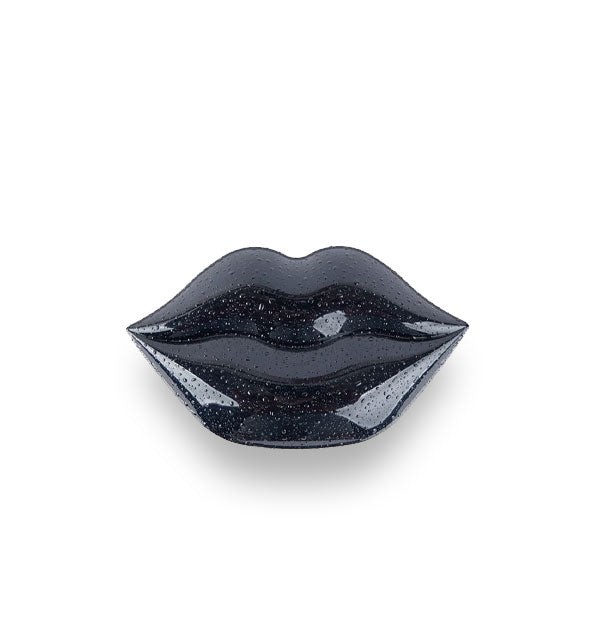 Black lip mask container shaped like a pair of lips