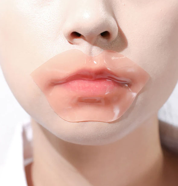 Model wears a pink lip-shaped mask over mouth